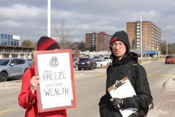 Photo of two ACORN protestors attending a demonstration in front of the Sobey's in the Bridgeport Plaza to decry the rising price of food in the region.