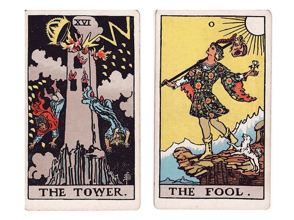 Photo of two tarot cards, the Tower and The Fool, laid face up side by side on a white background.