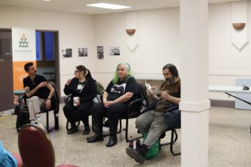 Members of Fightback! KW speaking, reading and listening to each other during a panel discussing "Laws vs. Justice"