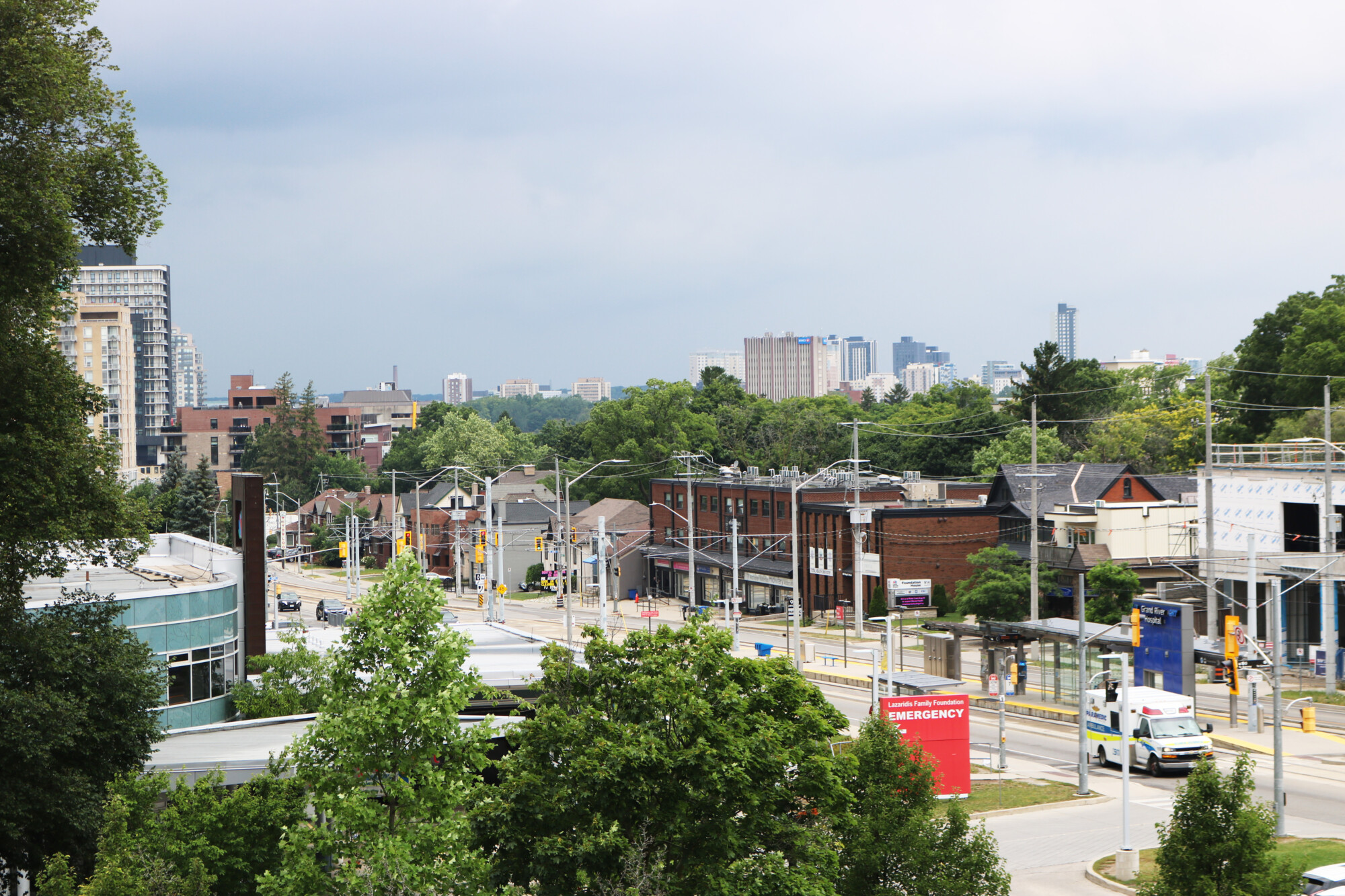 Photo taken from above of King Street in Kitchener, Ontario. The Grand River Hospital transit station is visible, as well as ambulances and sign indicating the entrance to the emergency room.